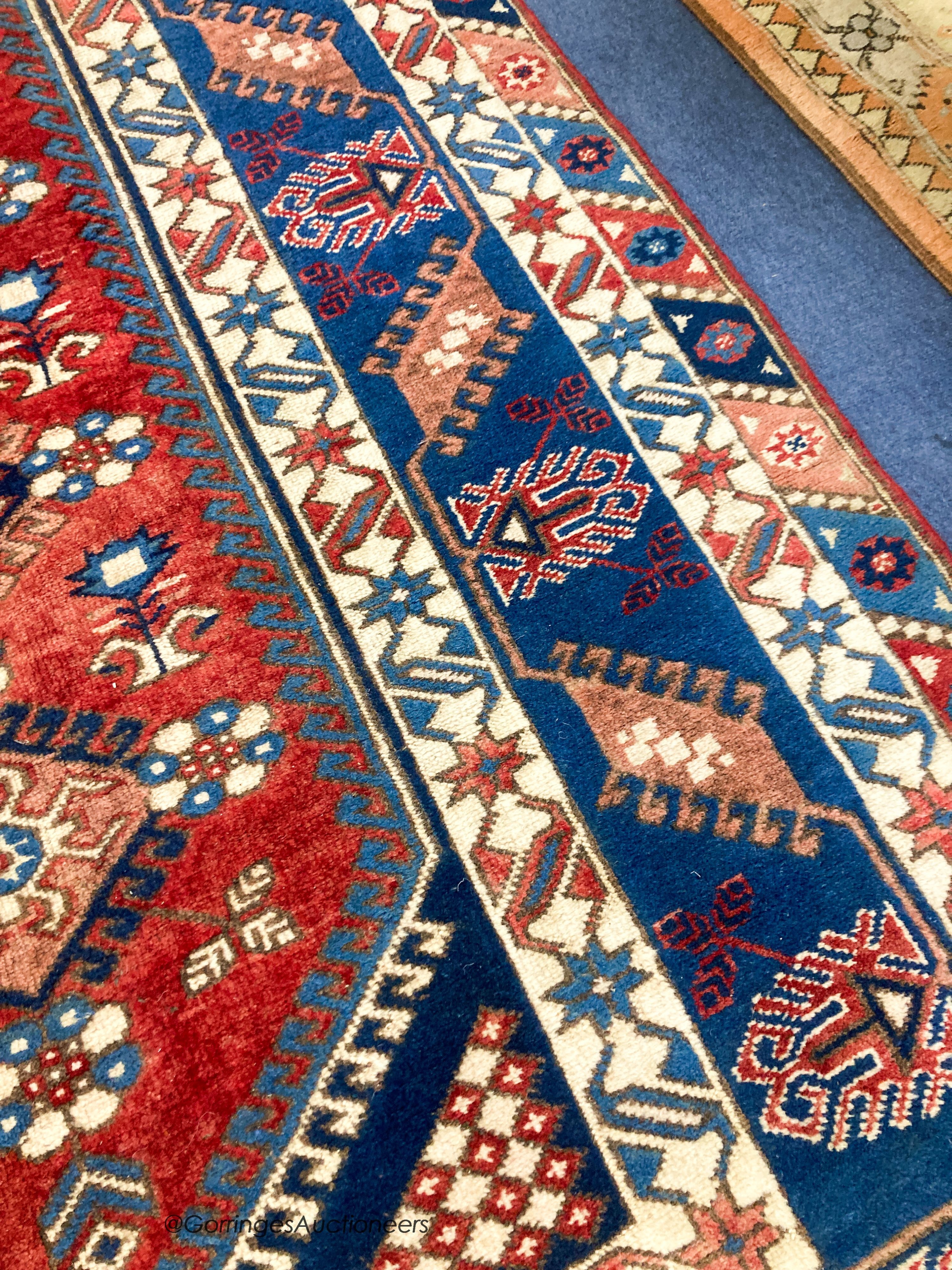 A Caucasian design blue ground rug, 240 x 152cm